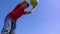 Young boy dribbles the ball against blue sky, slow motion