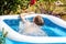 Young boy drowning in the swimming pool in the summer