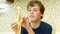 Young boy eating a banana with pleasure.