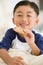 Young boy eating cookie in living room