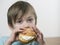 Young boy eating a cream bun