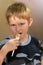 Young boy eating french fries