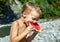 Young boy eating ripe watermelon