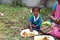 A young boy eats lunch sitting on the ground in Kumrokhali, West Bengal, India