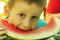 Young boy eats melon