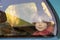 A young boy of eight or ten years old sits in a car behind glass. Car travel, train concept. Red-haired boy
