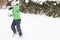 Young boy enjoying a winter snowball fight