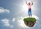 Young boy on floating rock platform in sky jumping