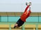 Young boy football or soccer goalkeeper jump parade