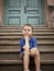 Young boy on the front steps of his school