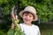 Young boy gardening at home showing his radish harvest