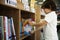 Young Boy Getting Children Story Book from Shelf in Library