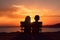 A young boy and girl embrace the beauty of togetherness, in the warm glow of the setting sun (Generative AI)