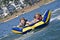 Young Boy and Girl Riding a Tube on Water