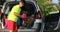 Young boy with glasses loaded the luggage in the trunk