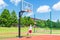 Young boy having fun playing basketball outdoors.nice,cool caucasian alone player playing basketball outdoors