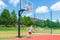 Young boy having fun playing basketball outdoors.nice,cool caucasian alone player playing basketball outdoors