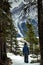 A young boy hiking a snow covered mountain trail