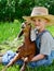 Young boy holding baby goat