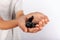 Young boy holding a black slime in his hands