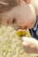 Young boy holding dandelion