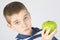 Young boy holding fresh green apple