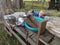 Young boy holding a lid and playing in a mud kitchen