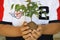 A Young boy holding Neem plant in his hands, selective focus image, selective background blur.