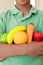 Young boy holding plastic fruit and vegetables