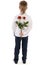 Young boy holding a roses behind back