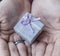 A young boy holds a vintage gift box in his hands