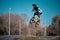 Young boy jumping with his BMX Bike at pump track