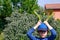 A young boy keeping two broad beans pods above his head pretending to be a rabbit. Children gardening. Easter rabbit