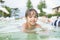 Young boy kid child splashing in swimming pool having fun leisure activity