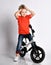 Young boy kid in orange t-shirt biker ride bicycle happy screaming