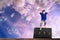 Young Boy Leaps Over an Old Steamer Trunk in Front of a Colorful