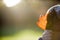 Young boy learns about nature oudoors by having fun studying a leaf close up in the park