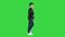 Young boy in a leather jacket walking with his hands in his pockets on a Green Screen, Chroma Key.