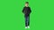 Young boy in a leather jacket walking with his hands in his pockets on a Green Screen, Chroma Key.