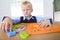 Young boy with letters jigsaw