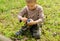 Young boy lighting a fire outdoors