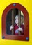 Young boy looking through bars of a window in a kids playground