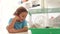 Young Boy Looking At Pet Hamster In Cage