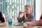 Young boy looking tired at the kitchen table eating toast for breakfast