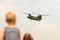 Young boy looks at a Chinook helicopter