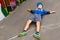 Young Boy Lying on Back in Lot near Graffiti Wall