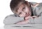 Young boy lying down on a floor with copy-book