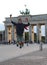 Young boy makes a big leap in the Berlin square in front of the