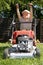 Young boy mowing grass