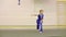 Young boy in national Chinese dress is practicing Kung Fu wushu tai chi Nanquan form